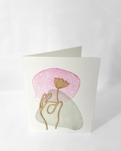 Hand with flower wooden greeting card